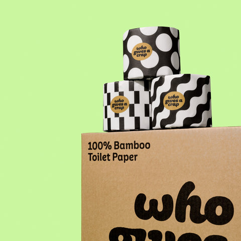 Bamboo Toilet Paper in black and white designed packaging stacked on shipping box
